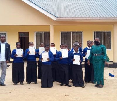 Principle of FDC Collegee handing over certificate of completion of Electricity course for OVC Out of schooll at VETA FDC Njombe